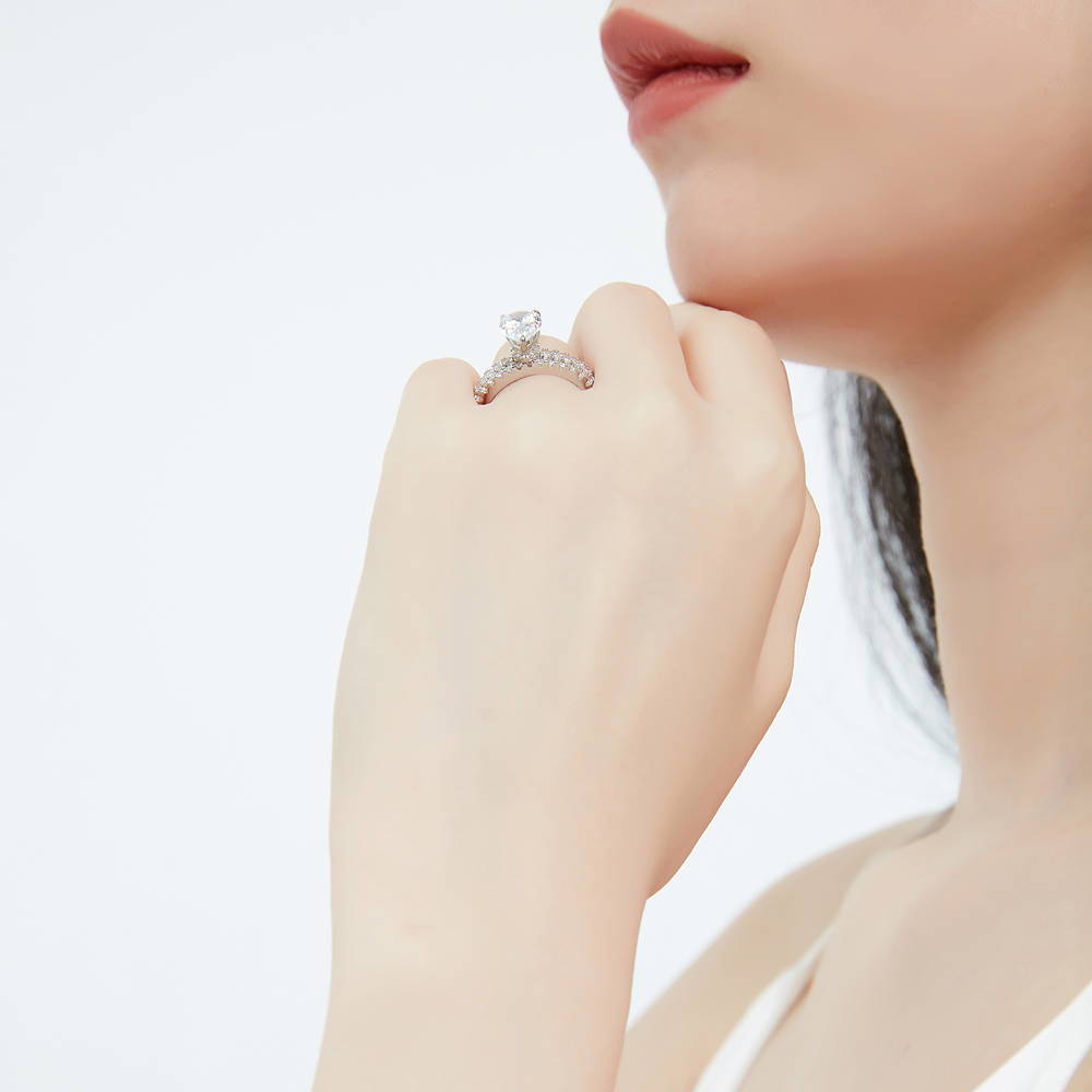 Model wearing Solitaire Hidden Halo 1.8ct Pear CZ Ring Set in Sterling Silver, 6 of 12