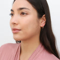 Model wearing Oval Bar CZ Medium Hoop Earrings in Sterling Silver 0.6 inch, Yellow Gold Flashed