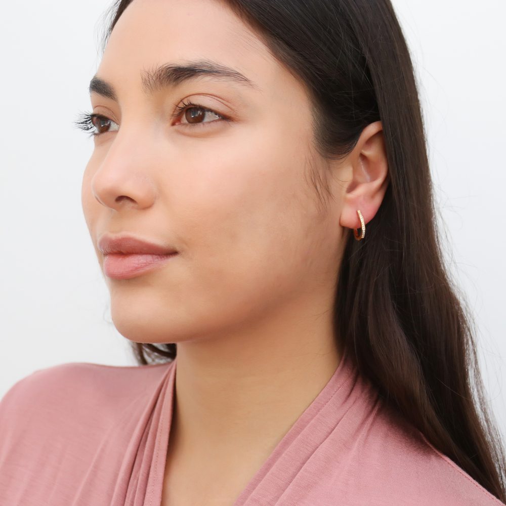 Model wearing Oval Bar CZ Small Hoop Earrings in Sterling Silver 0.6 inch, Yellow Gold Flashed