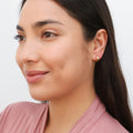 Model wearing Dome Small Huggie Earrings in Sterling Silver 0.5 inch, Yellow Gold Flashed