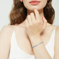 Model wearing CZ Tennis Bracelet in Sterling Silver 4-9 inch, Blue Color