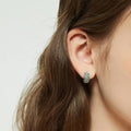 Model wearing CZ Small Huggie Earrings in Sterling Silver 0.5 inch, Green Color