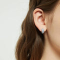 Model wearing CZ Small Huggie Earrings in Sterling Silver 0.5 inch, Blue Color