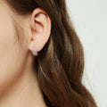 Model wearing CZ Small Huggie Earrings in Sterling Silver 0.5 inch, Pink Color