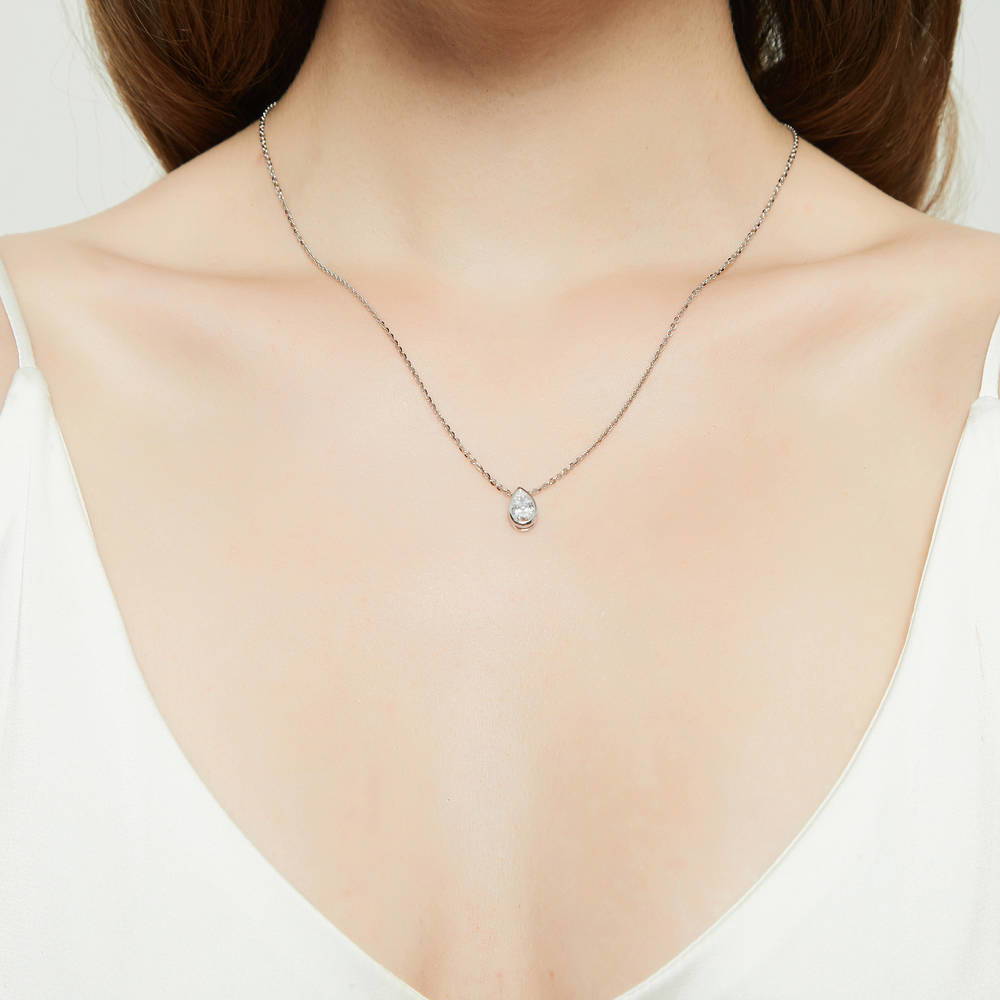 Model wearing Solitaire 0.8ct Bezel Pear CZ Necklace in Sterling Silver, 2 of 5