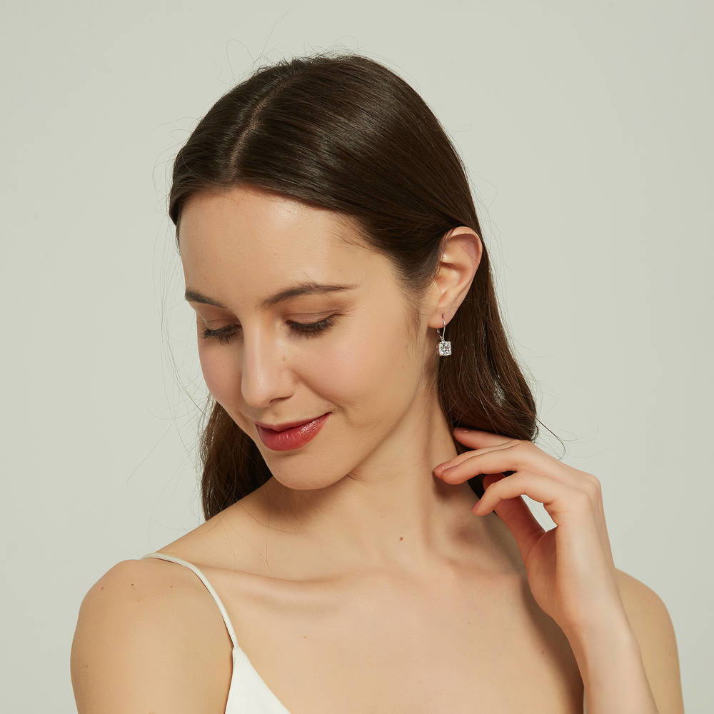 Model wearing Solitaire 6ct Cushion CZ Leverback Earrings in Sterling Silver, 3 of 5