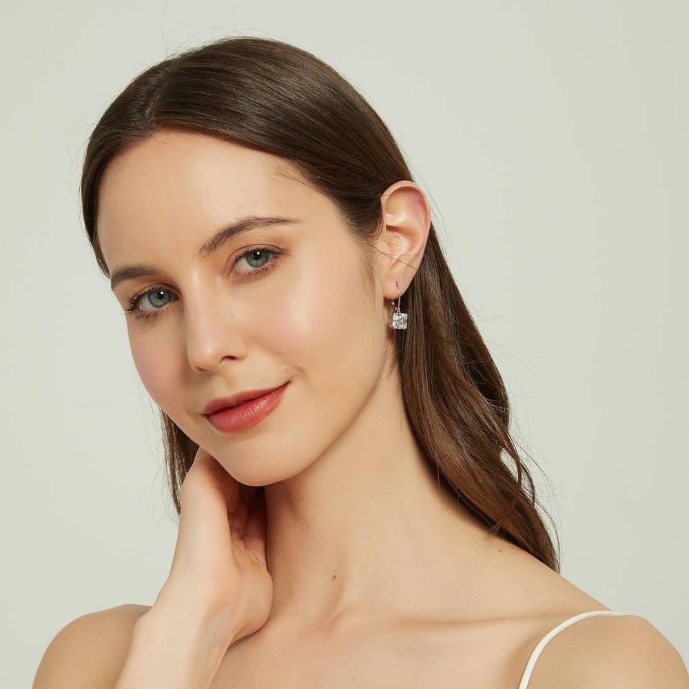 Model wearing Solitaire 6ct Asscher CZ Leverback Earrings in Sterling Silver, 3 of 5