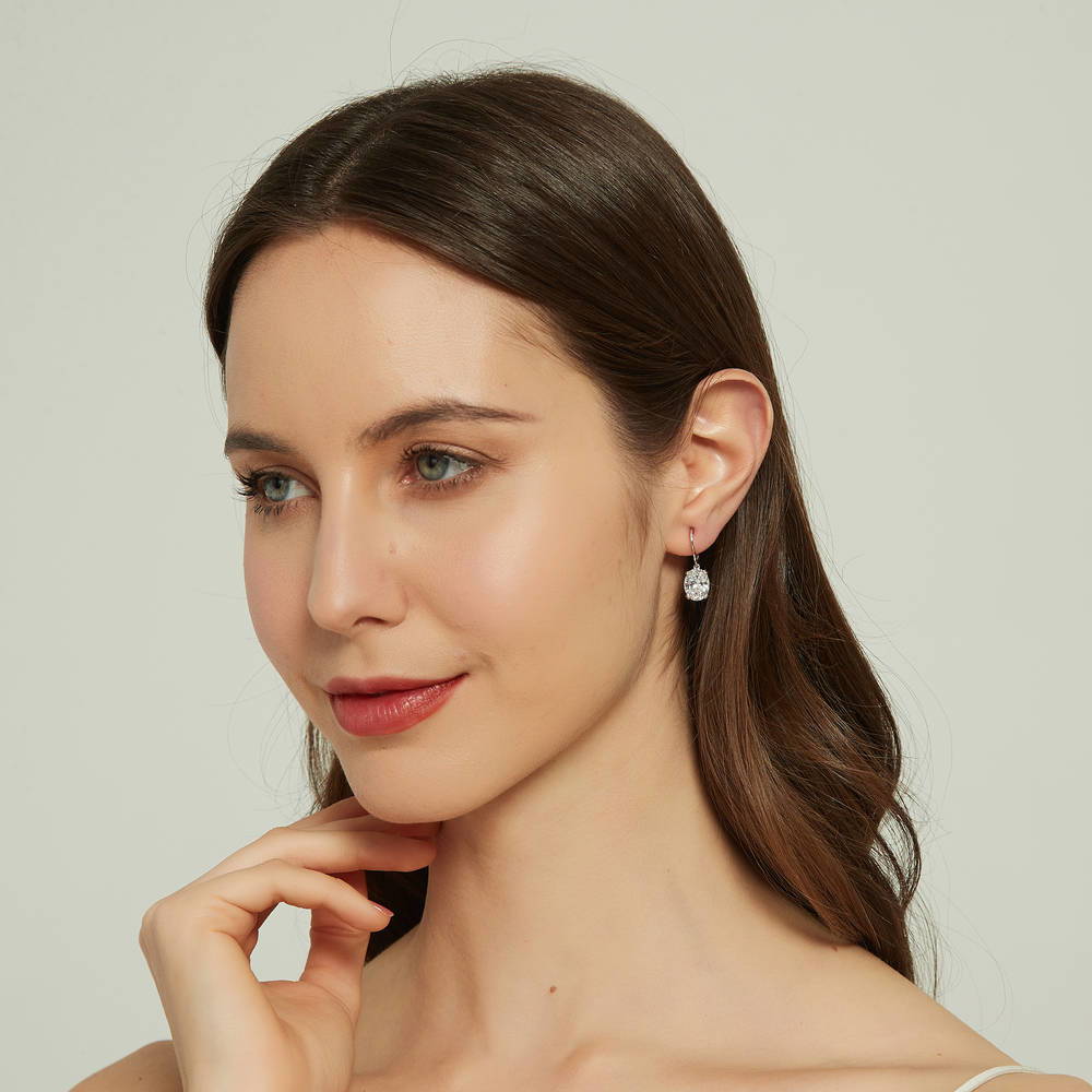 Model wearing Solitaire 5.6ct Oval CZ Leverback Earrings in Sterling Silver, 5 of 5