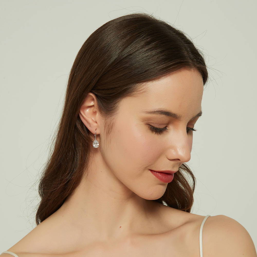 Model wearing Solitaire 5.6ct Oval CZ Leverback Earrings in Sterling Silver, 4 of 5