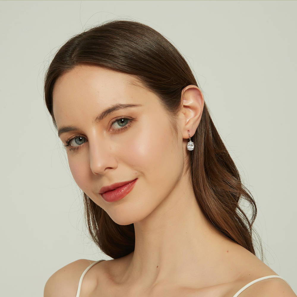 Model wearing Solitaire 5.6ct Oval CZ Leverback Earrings in Sterling Silver, 3 of 5