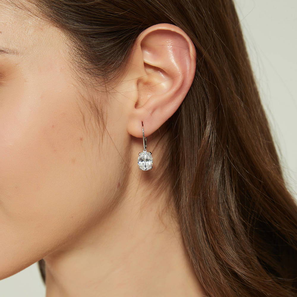 Model wearing Solitaire 5.6ct Oval CZ Leverback Earrings in Sterling Silver, 2 of 5