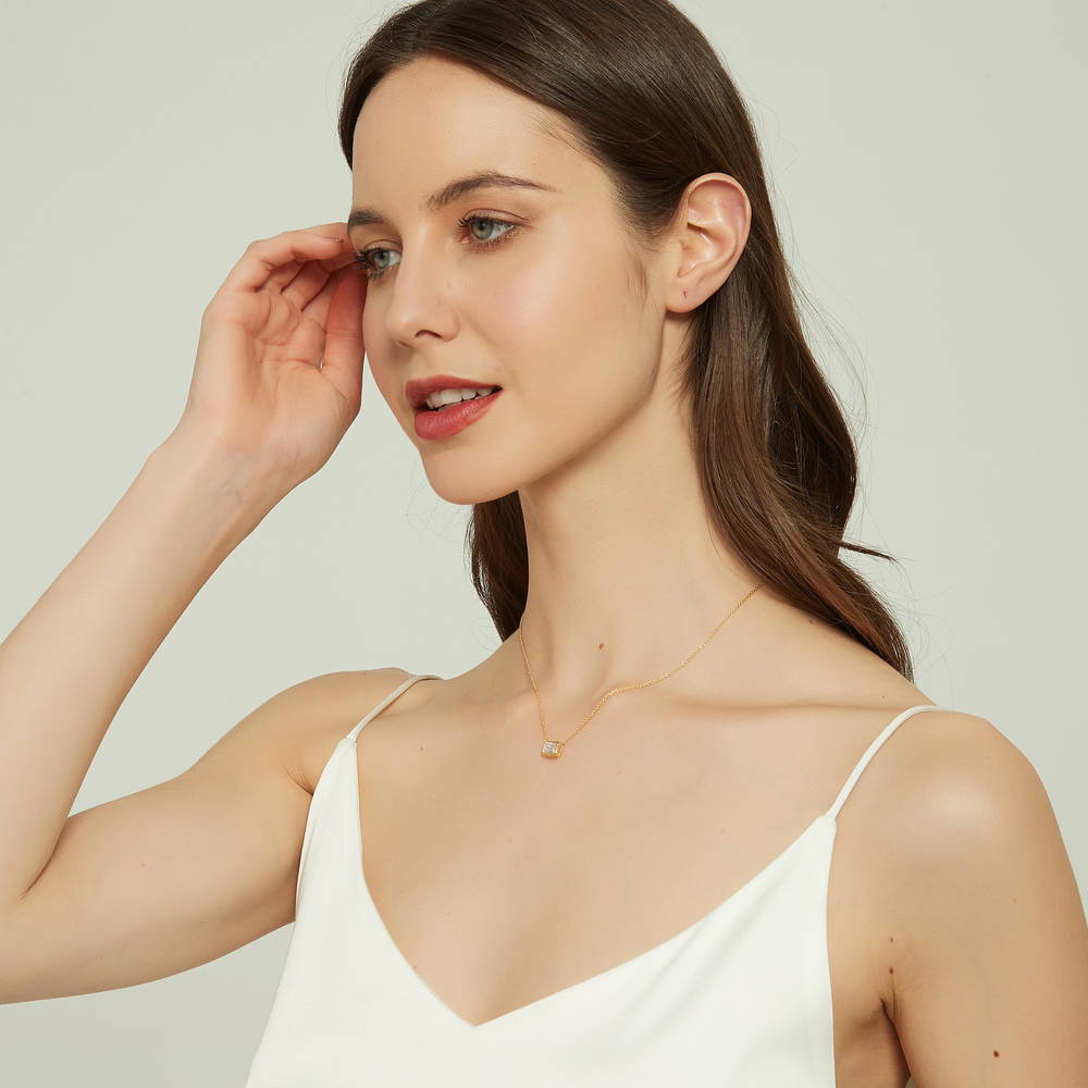 Model wearing Solitaire East-West CZ Necklace in Gold Flashed Sterling Silver, 5 of 8