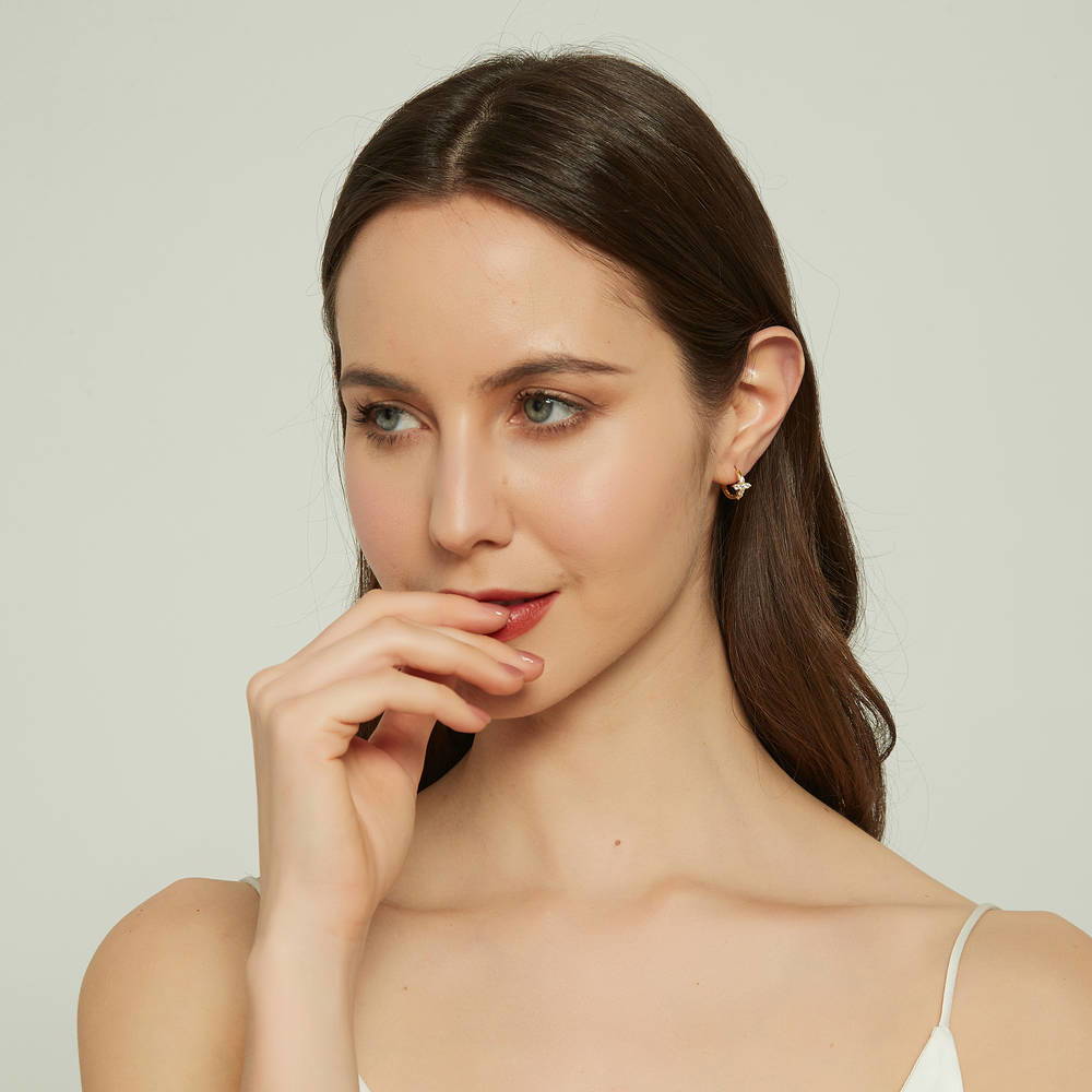 Model wearing Cross CZ Mini Huggie Earrings in Sterling Silver 0.5 inch, Yellow Gold Flashed