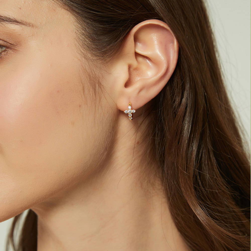 Model wearing Cross CZ Mini Huggie Earrings in Sterling Silver 0.5 inch, Yellow Gold Flashed