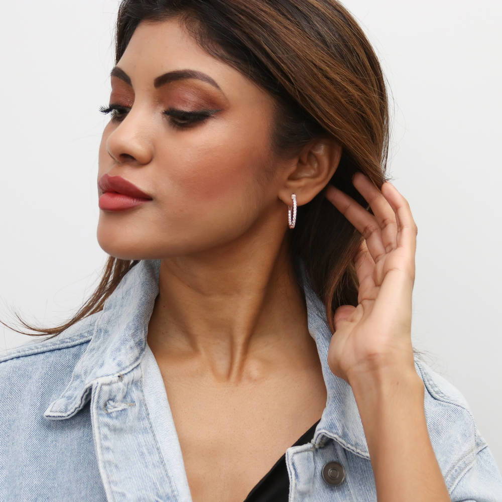 Model wearing Oval CZ Small Inside-Out Hoop Earrings in Sterling Silver 0.8 inch, Rose Gold Flashed