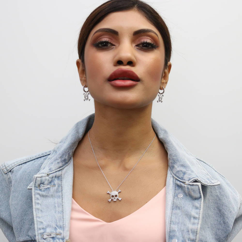 Model wearing Skull Bones CZ Earrings in Sterling Silver, 5 of 6