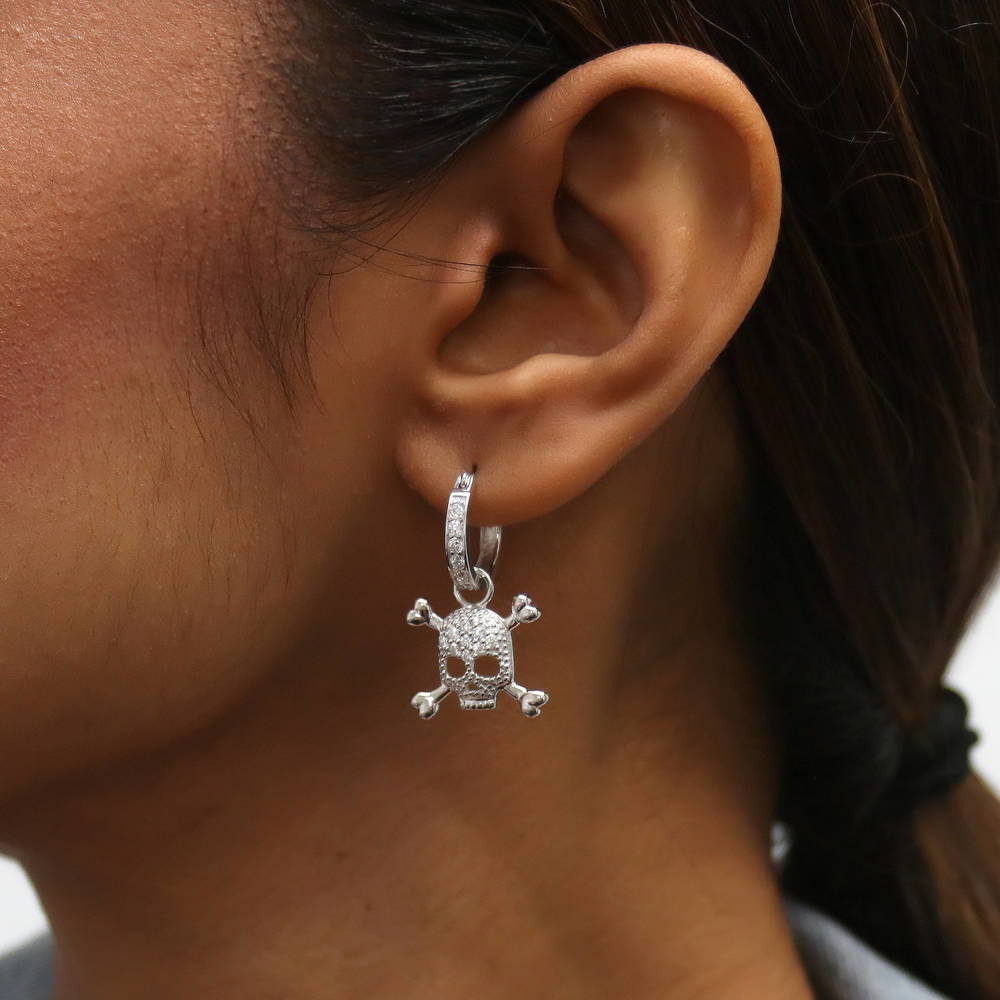 Model wearing Skull Bones CZ Earrings in Sterling Silver, 2 of 6