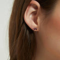 Model wearing Solitaire Kaleidoscope CZ Stud Earrings in Sterling Silver 2.5ct, Red Orange Color