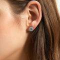 Model wearing Halo Kaleidoscope CZ Stud Earrings in Sterling Silver, Greyish Blue Color