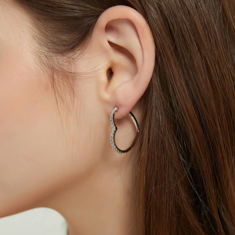 Model wearing Heart CZ Small Hoop Earrings in Sterling Silver 1 inch, 2 of 5