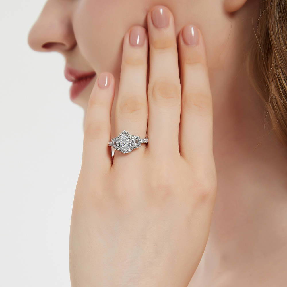 Model wearing 3-Stone Halo Art Deco 1.3ct Pear CZ Ring in Sterling Silver, 2 of 9