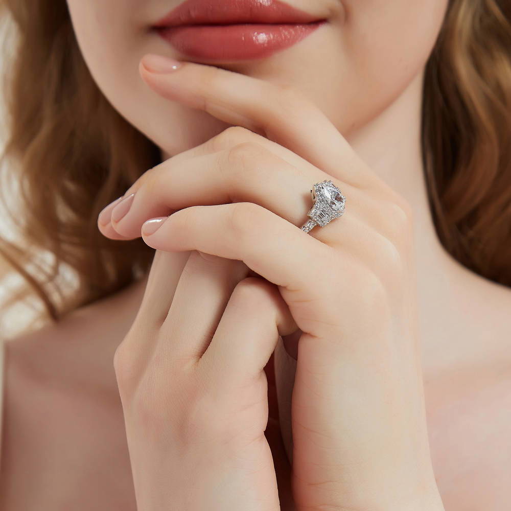 Model wearing 3-Stone Halo Art Deco 1.3ct Pear CZ Ring in Sterling Silver, 3 of 9