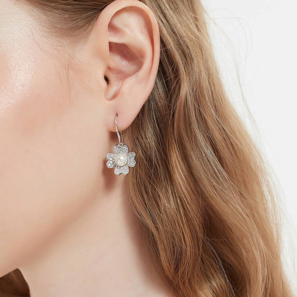 Model wearing Clover Imitation Pearl Fish Hook Earrings in Sterling Silver, 2 of 3