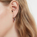 Model wearing Solitaire Pear CZ Leverback Earrings in Sterling Silver, Red Color