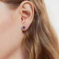 Model wearing Halo Kaleidoscope CZ Stud Earrings in Sterling Silver, Red Color