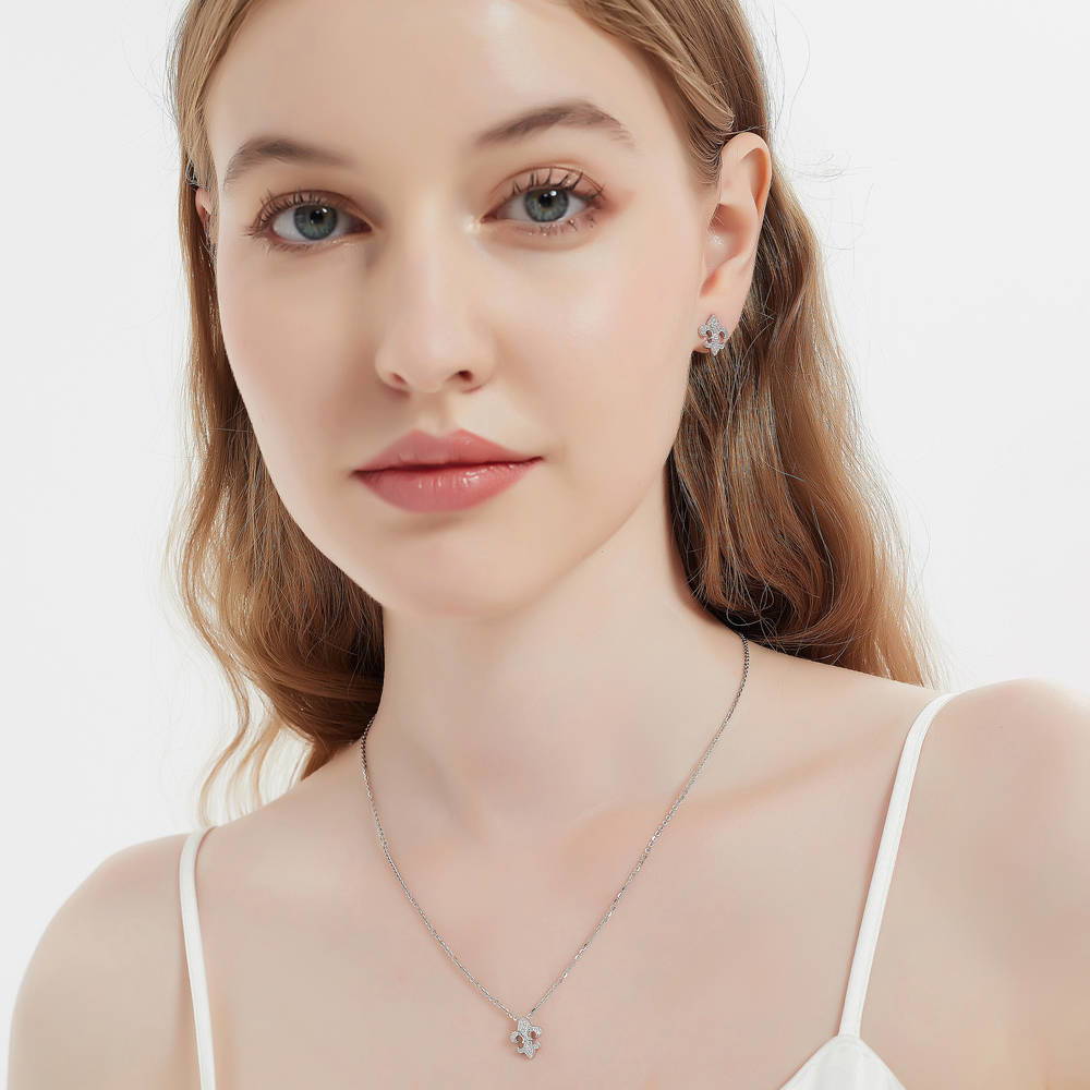 Model wearing Fleur De Lis CZ Necklace and Huggie Earrings Set in Sterling Silver, 17 of 18