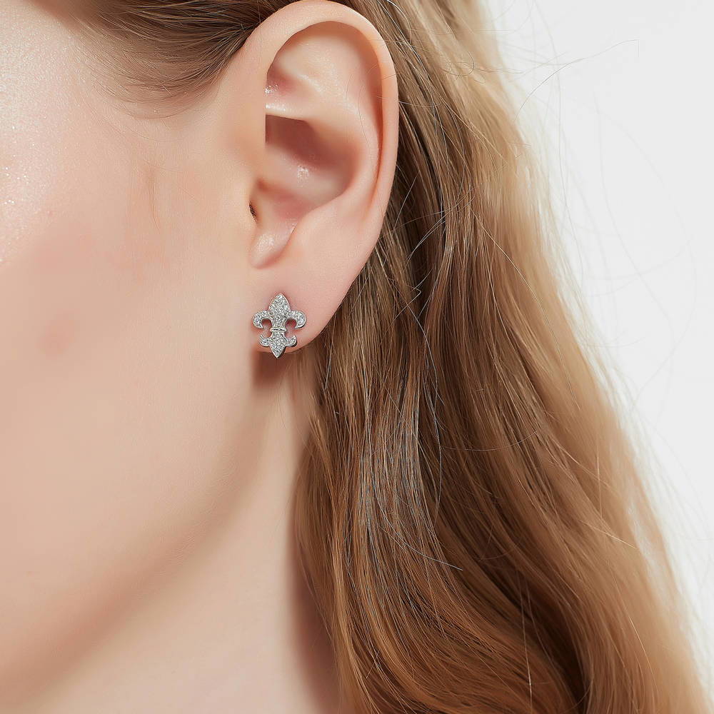 Model wearing Fleur De Lis CZ Stud Earrings in Sterling Silver, 2 of 5