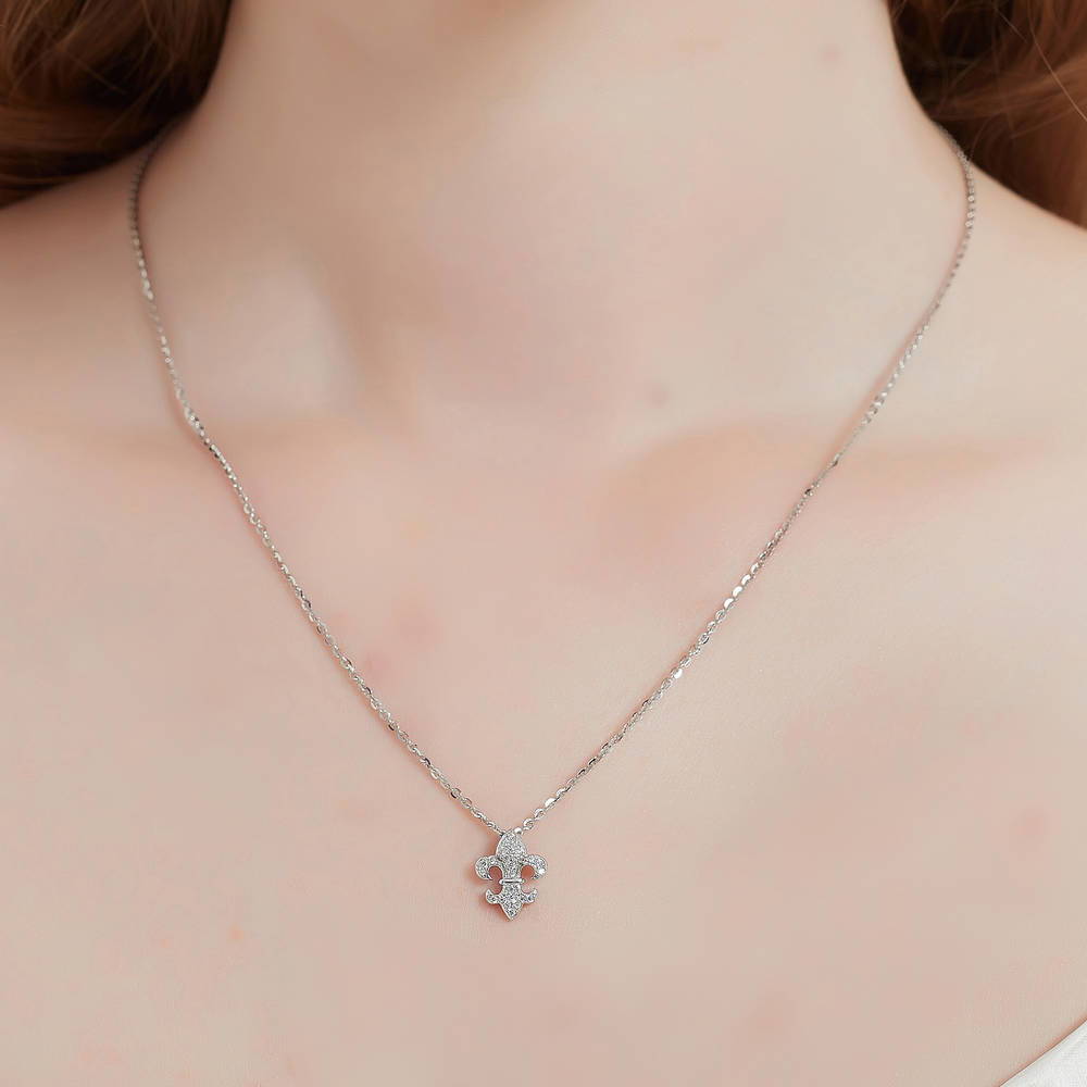 Model wearing Fleur De Lis CZ Necklace and Earrings in Sterling Silver, 11 of 14