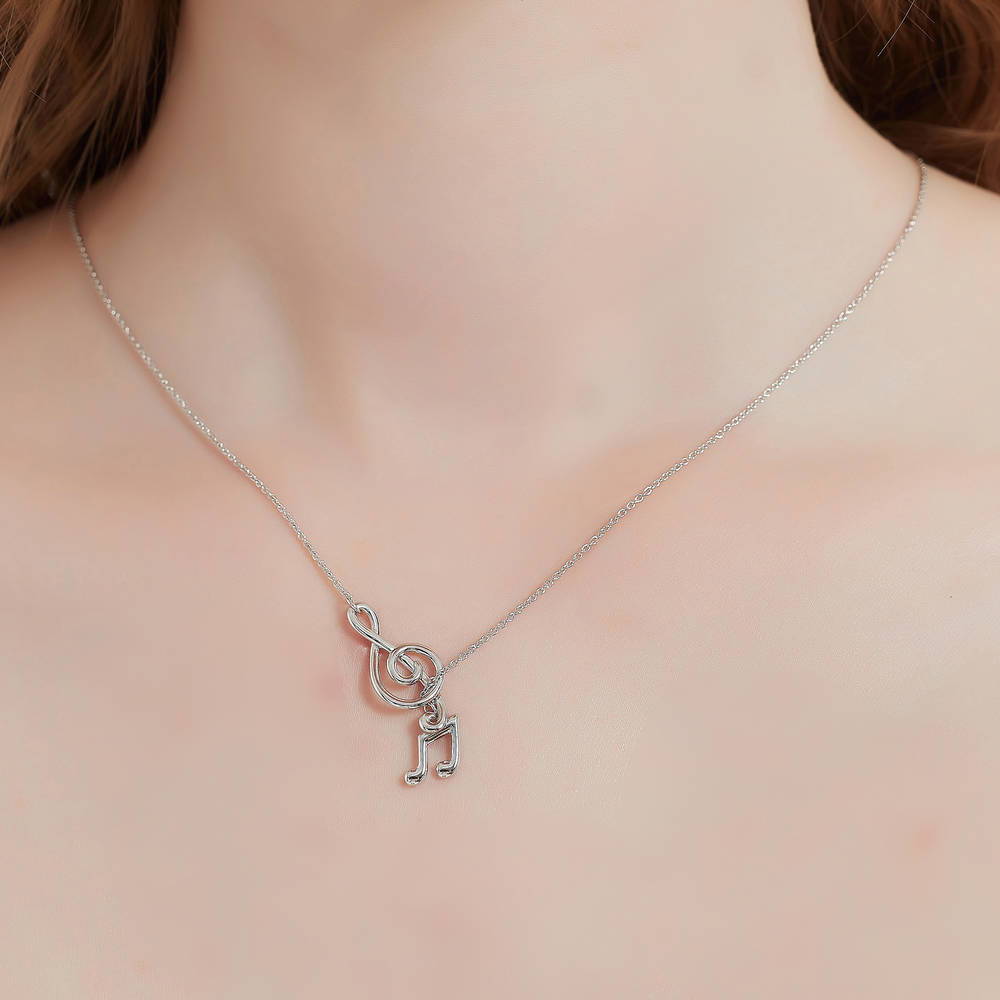 Model wearing Treble Clef Music Note Lariat Necklace in Sterling Silver, 2 of 9