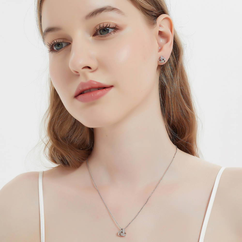 Model wearing Love Knot CZ Stud Earrings in Sterling Silver, 3 of 7
