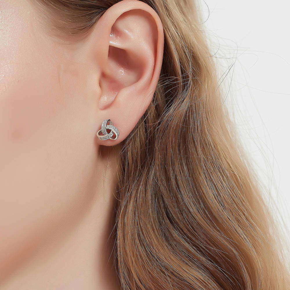 Model wearing Love Knot CZ Stud Earrings in Sterling Silver, 2 of 7