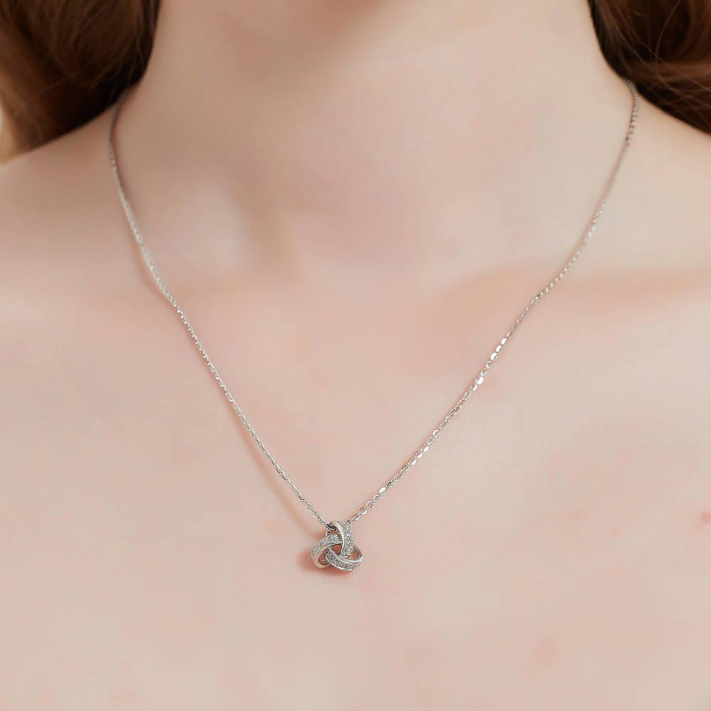 Model wearing Love Knot CZ Necklace and Earrings in Sterling Silver, 6 of 14