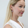 Model wearing Halo Kaleidoscope CZ Fish Hook Earrings in Sterling Silver, Purple Aqua Color