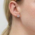 Model wearing Halo CZ Stud Earrings in Sterling Silver, Rose Gold Flashed