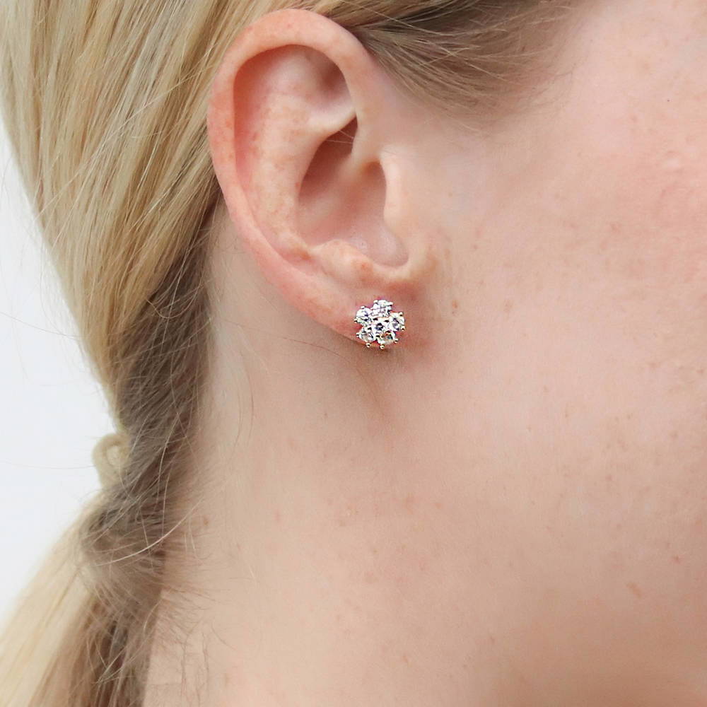 Model wearing Flower CZ Stud Earrings in Sterling Silver, Yellow Gold Flashed