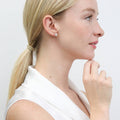 Model wearing Flower CZ Stud Earrings in Sterling Silver, Rose Gold Flashed