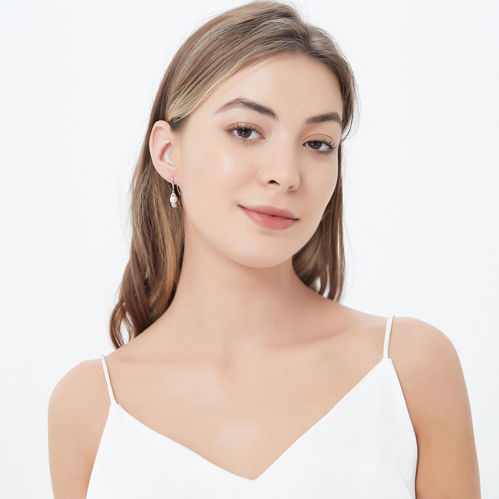 Model wearing Ball Bead Imitation Pearl Fish Hook Earrings in Sterling Silver, 3 of 4