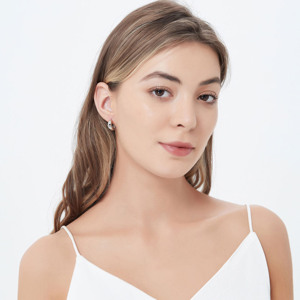 Model wearing Dome Small Hoop Earrings in Sterling Silver 0.6 inch, 3 of 3
