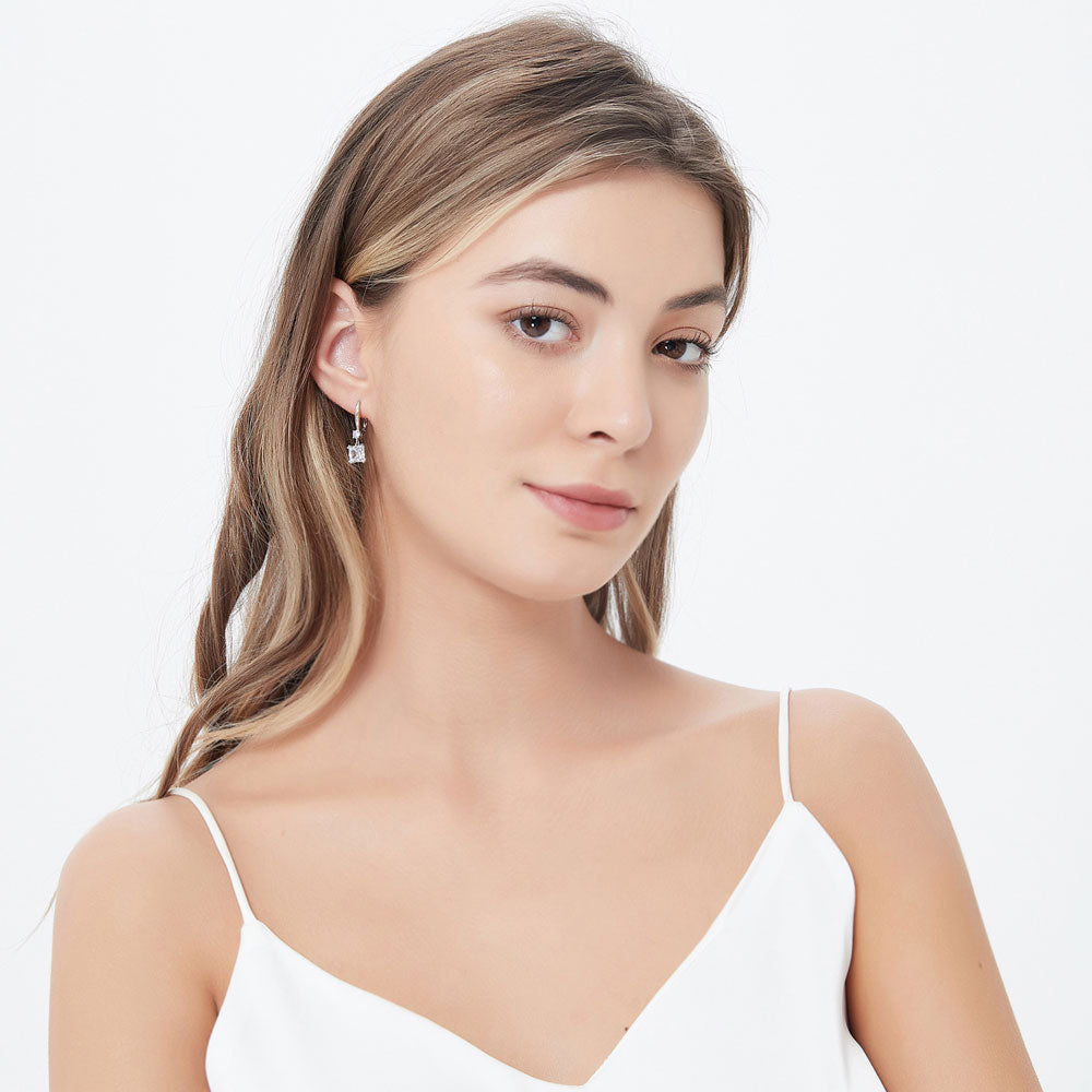 Model wearing Solitaire 3.2ct Princess CZ Leverback Earrings in Sterling Silver, 3 of 4