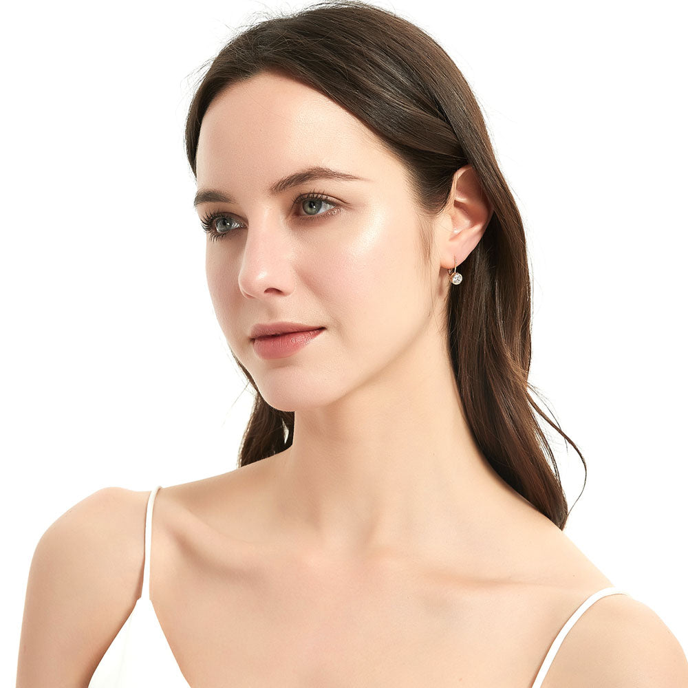 Model wearing Solitaire 1.2ct Bezel CZ Leverback Earrings in Sterling Silver, Yellow Gold Flashed
