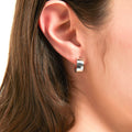 Model wearing Small Huggie Earrings in Sterling Silver 0.55 inch, Rhodium Plated