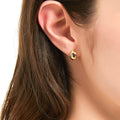 Model wearing Dome Mini Huggie Earrings in Sterling Silver 0.45 inch, Yellow Gold Flashed