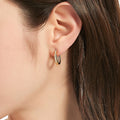 Model wearing Oval Bar CZ Medium Hoop Earrings in Sterling Silver 0.65 inch, Yellow Gold Flashed