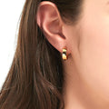 Model wearing Medium Hoop Earrings in Sterling Silver 0.6 inch, Yellow Gold Flashed