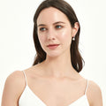 Model wearing Solitaire Cultured Pearl Stud Earrings in Sterling Silver, Yellow Gold Flashed