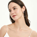 Model wearing Dome CZ Medium Hoop Earrings in Sterling Silver, 0.62 inch